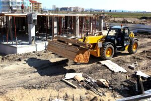A construction crew sets panels and beams on a partially built single-family home under a bright sky.