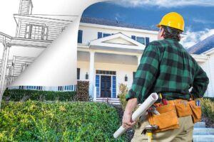 A couple compares house plans beside an existing home while reviewing construction costs and renovation needs.