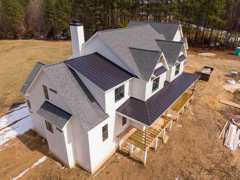 Homebuyer reviewing a new house with a construction representative, checklist, and unfinished interior details visible.